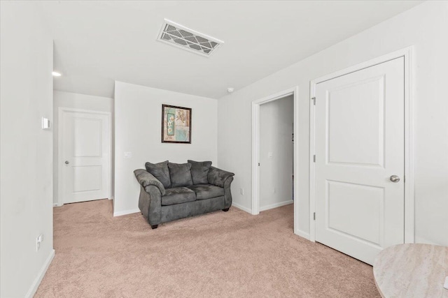 sitting room featuring light colored carpet