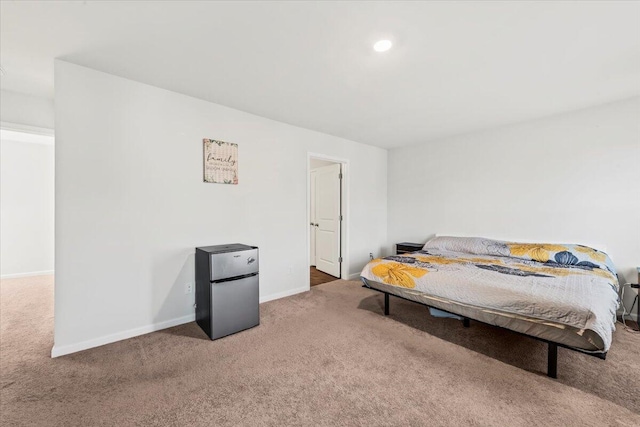 bedroom featuring stainless steel refrigerator and carpet floors