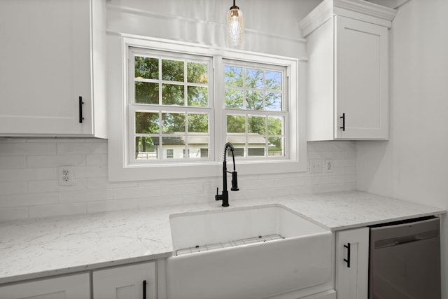 kitchen with dishwasher, a sink, white cabinetry, and tasteful backsplash