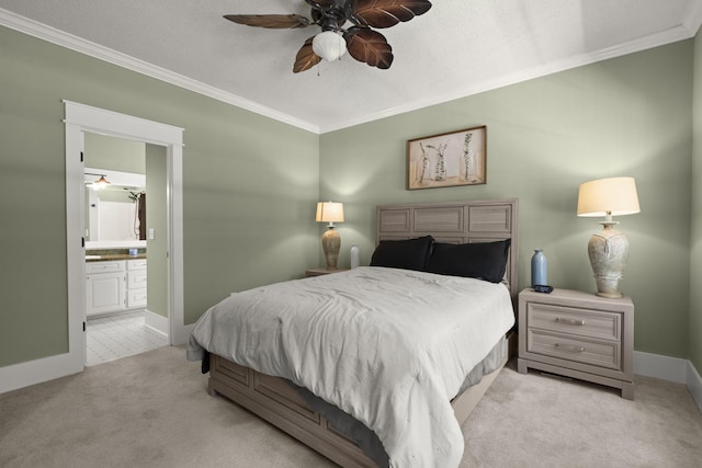 bedroom with ornamental molding, carpet flooring, ensuite bathroom, baseboards, and ceiling fan