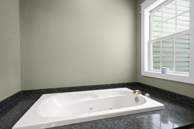 full bathroom with a jetted tub