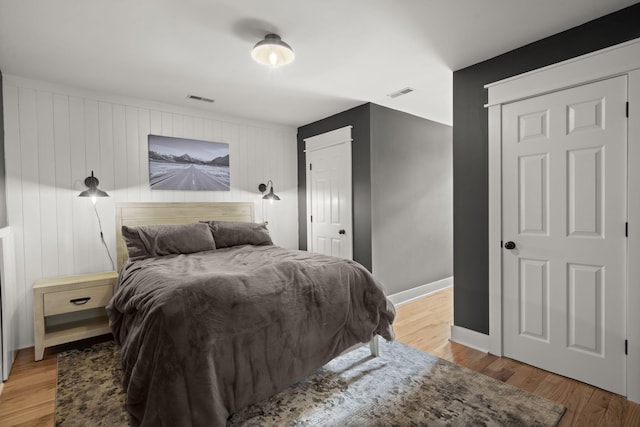bedroom with light wood-style flooring and baseboards