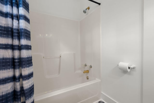 full bathroom featuring shower / bath combination with curtain and baseboards