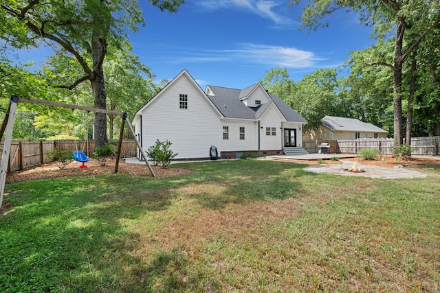 rear view of property with a fire pit, a patio area, and french doors