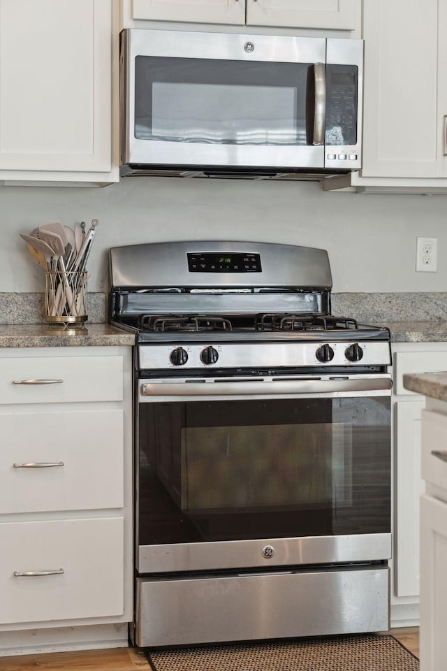 kitchen featuring white cabinetry and appliances with stainless steel finishes