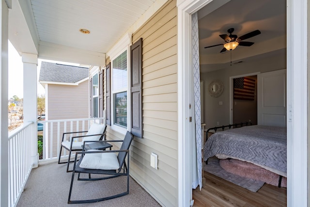 balcony with covered porch and ceiling fan