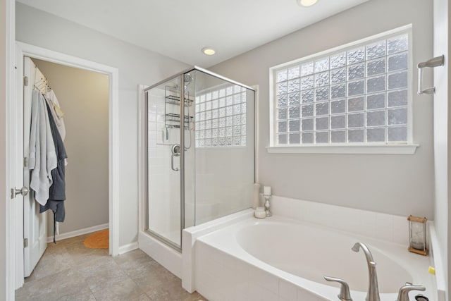 bathroom featuring separate shower and tub