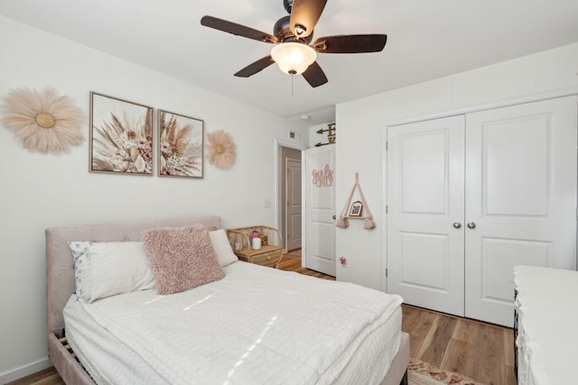 bedroom with a closet, ceiling fan, and light wood-type flooring