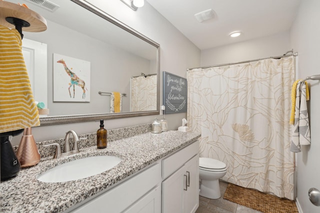 bathroom featuring a shower with curtain, vanity, toilet, and tile patterned flooring