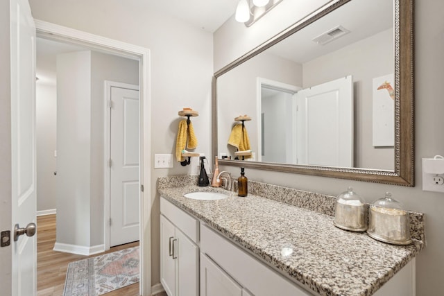 bathroom with vanity and hardwood / wood-style flooring