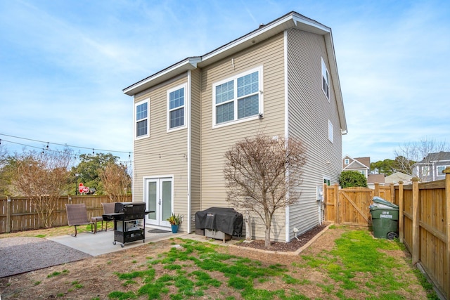 back of property with french doors and a patio