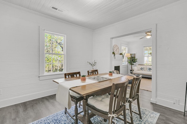 dining room with visible vents, dark wood-type flooring, and crown molding