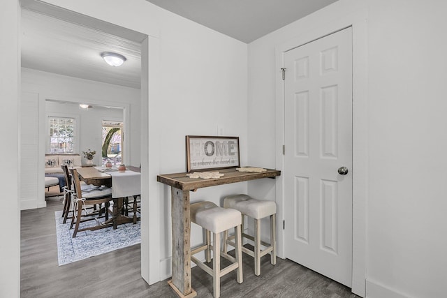 interior space featuring baseboards and wood finished floors