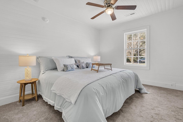 carpeted bedroom with a ceiling fan and visible vents