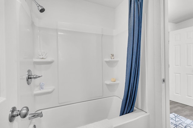 bathroom featuring shower / bath combination with curtain and wood finished floors