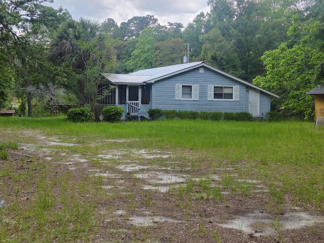 126 Rattlensnake Trl, Walterboro, SC 29488 - view of front facade featuring a metal roof, a sunroom, and a view of trees