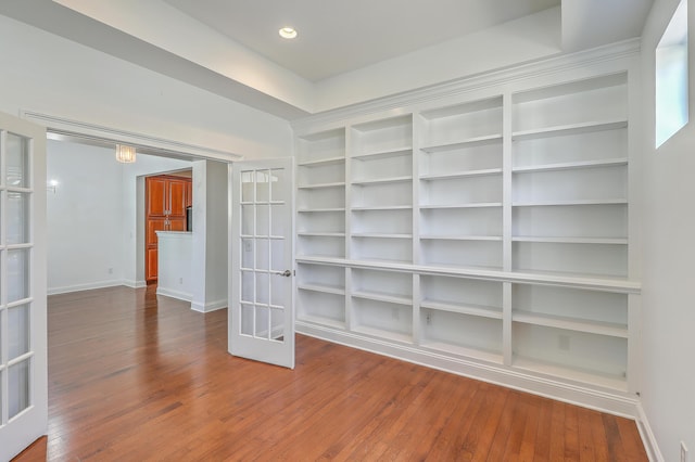 spare room featuring french doors and wood-type flooring