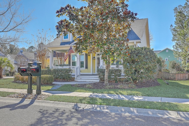 obstructed view of property with a front lawn and a porch