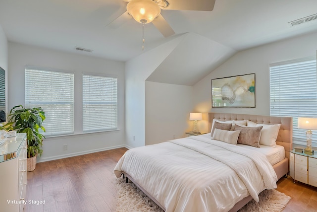 bedroom featuring ceiling fan, lofted ceiling, and wood-type flooring