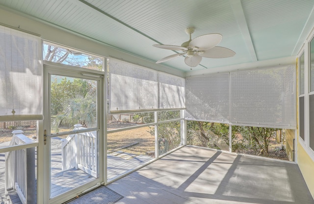 unfurnished sunroom with ceiling fan