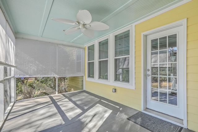 unfurnished sunroom with ceiling fan