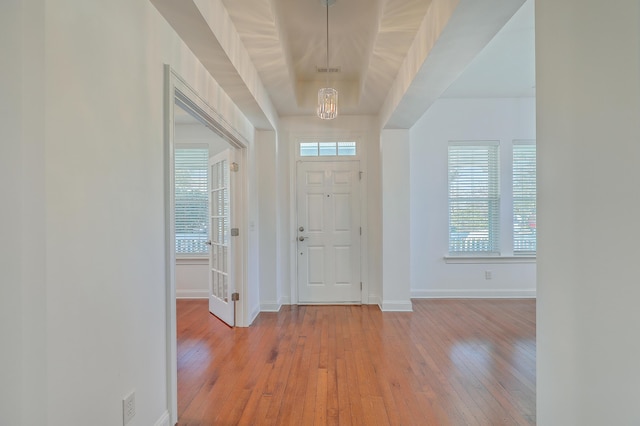 entryway featuring light hardwood / wood-style floors and a chandelier