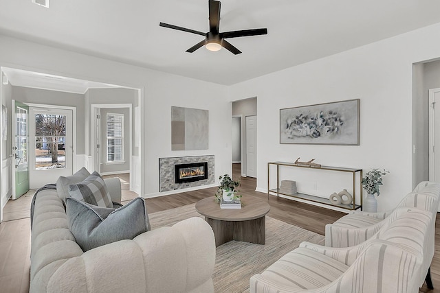 living room featuring light wood-type flooring and ceiling fan