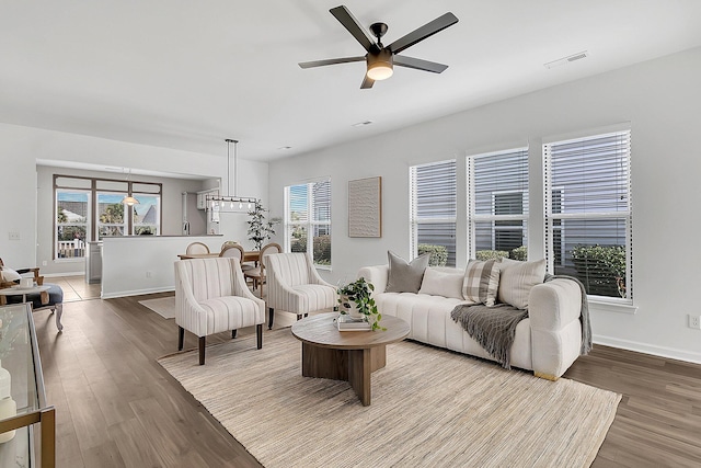 living room with hardwood / wood-style flooring, plenty of natural light, and ceiling fan