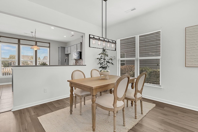 dining room featuring sink and dark hardwood / wood-style floors