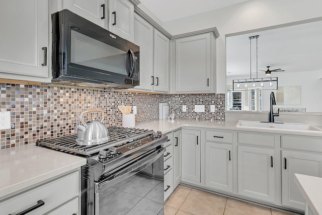 kitchen with black appliances, sink, backsplash, ceiling fan, and light tile patterned flooring