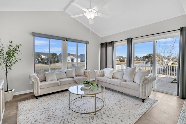 living room with high vaulted ceiling, a healthy amount of sunlight, light tile patterned floors, and ceiling fan