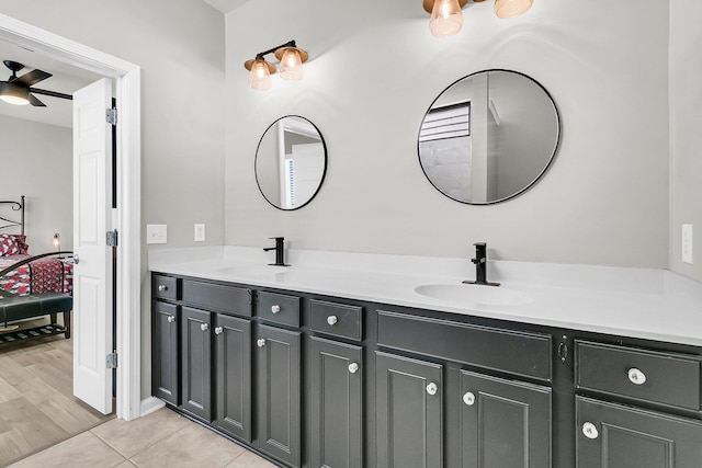 bathroom with tile patterned floors, vanity, and ceiling fan