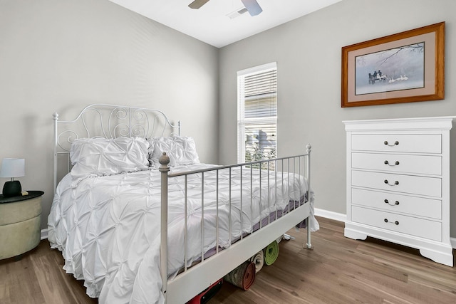 bedroom with ceiling fan and wood-type flooring