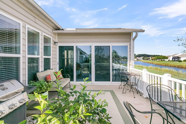 view of patio / terrace with a water view and grilling area