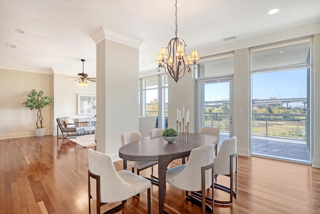 dining room featuring ornamental molding, ceiling fan with notable chandelier, and light wood-type flooring