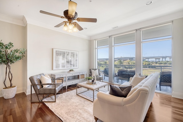 living room featuring crown molding, dark hardwood / wood-style flooring, and ceiling fan