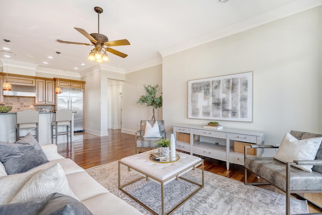 living room with crown molding, dark hardwood / wood-style flooring, and ceiling fan