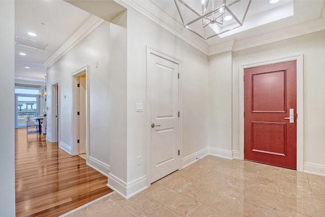 entrance foyer with ornamental molding and light wood-type flooring