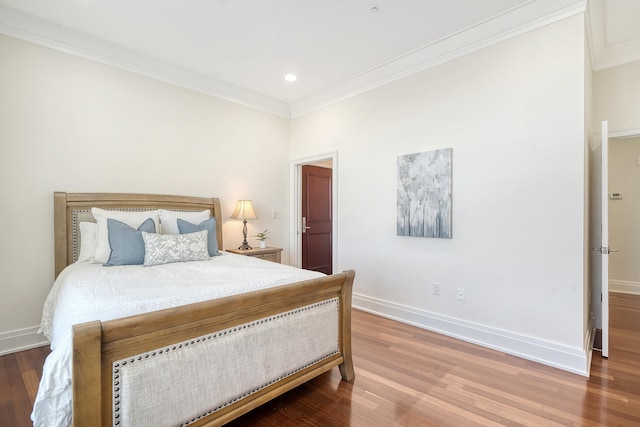 bedroom with crown molding and wood-type flooring