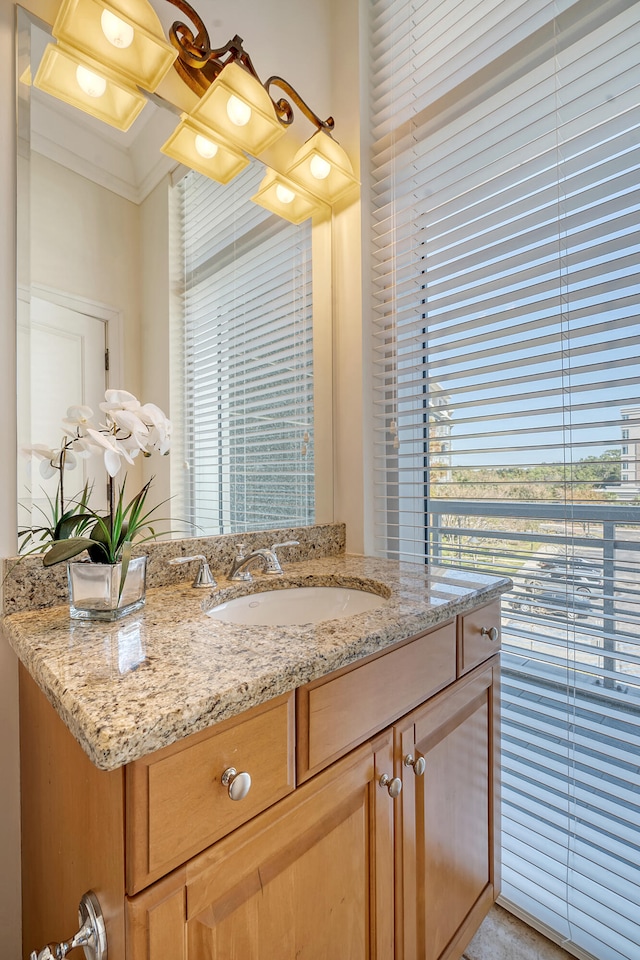 bathroom with vanity and crown molding