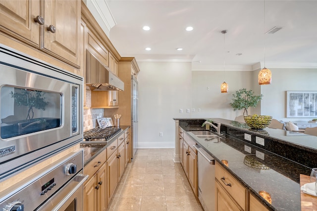 kitchen featuring sink, appliances with stainless steel finishes, pendant lighting, and dark stone counters