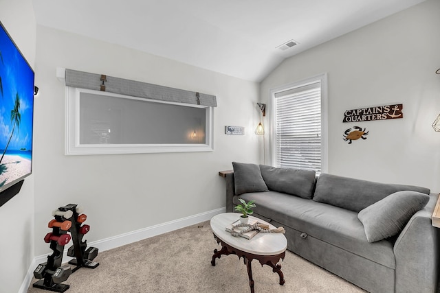 carpeted living room with baseboards, visible vents, and vaulted ceiling