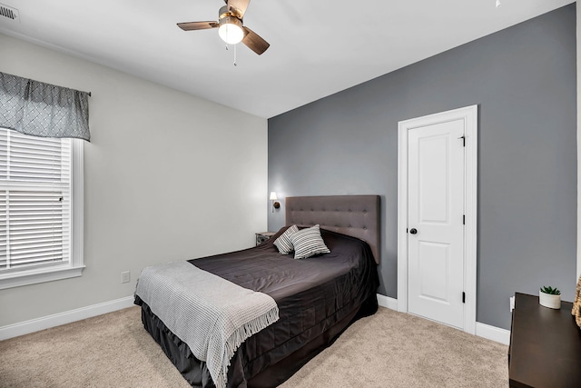 bedroom with baseboards, carpet flooring, visible vents, and a ceiling fan