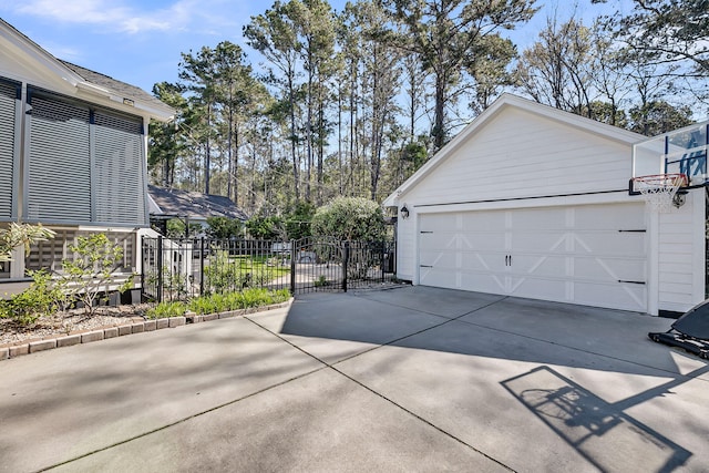 garage with driveway and fence
