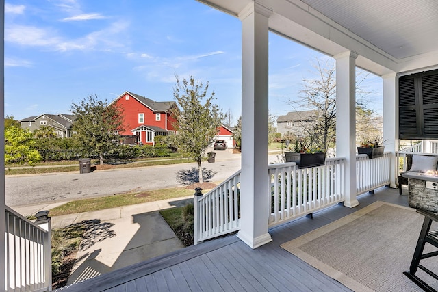 deck with a residential view and a porch