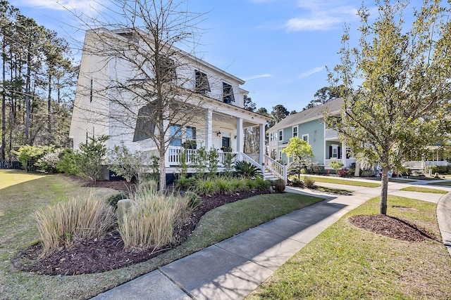 view of front of property with covered porch and a front yard