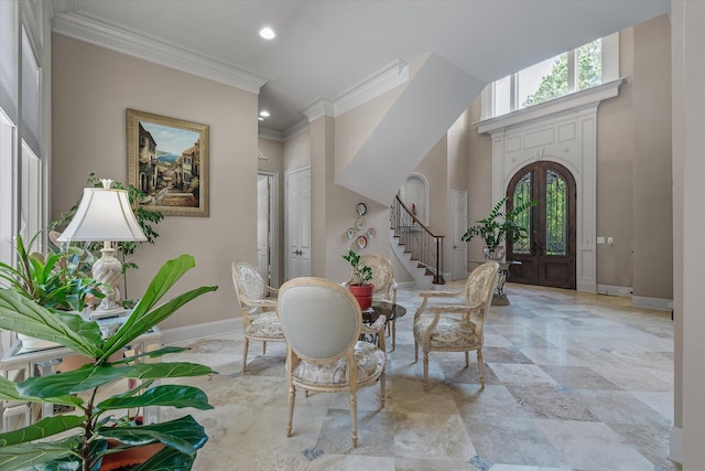 foyer with baseboards, crown molding, recessed lighting, a towering ceiling, and stairs