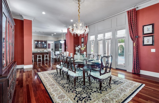 dining room with baseboards, ornamental molding, a chandelier, dark wood finished floors, and recessed lighting