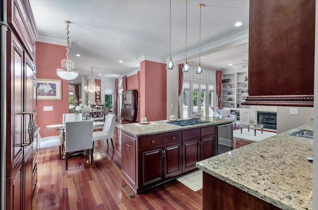 kitchen with ornamental molding, a chandelier, dark wood-type flooring, stainless steel gas cooktop, and wine cooler
