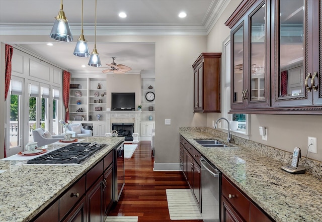 kitchen with hanging light fixtures, a sink, appliances with stainless steel finishes, a ceiling fan, and beverage cooler